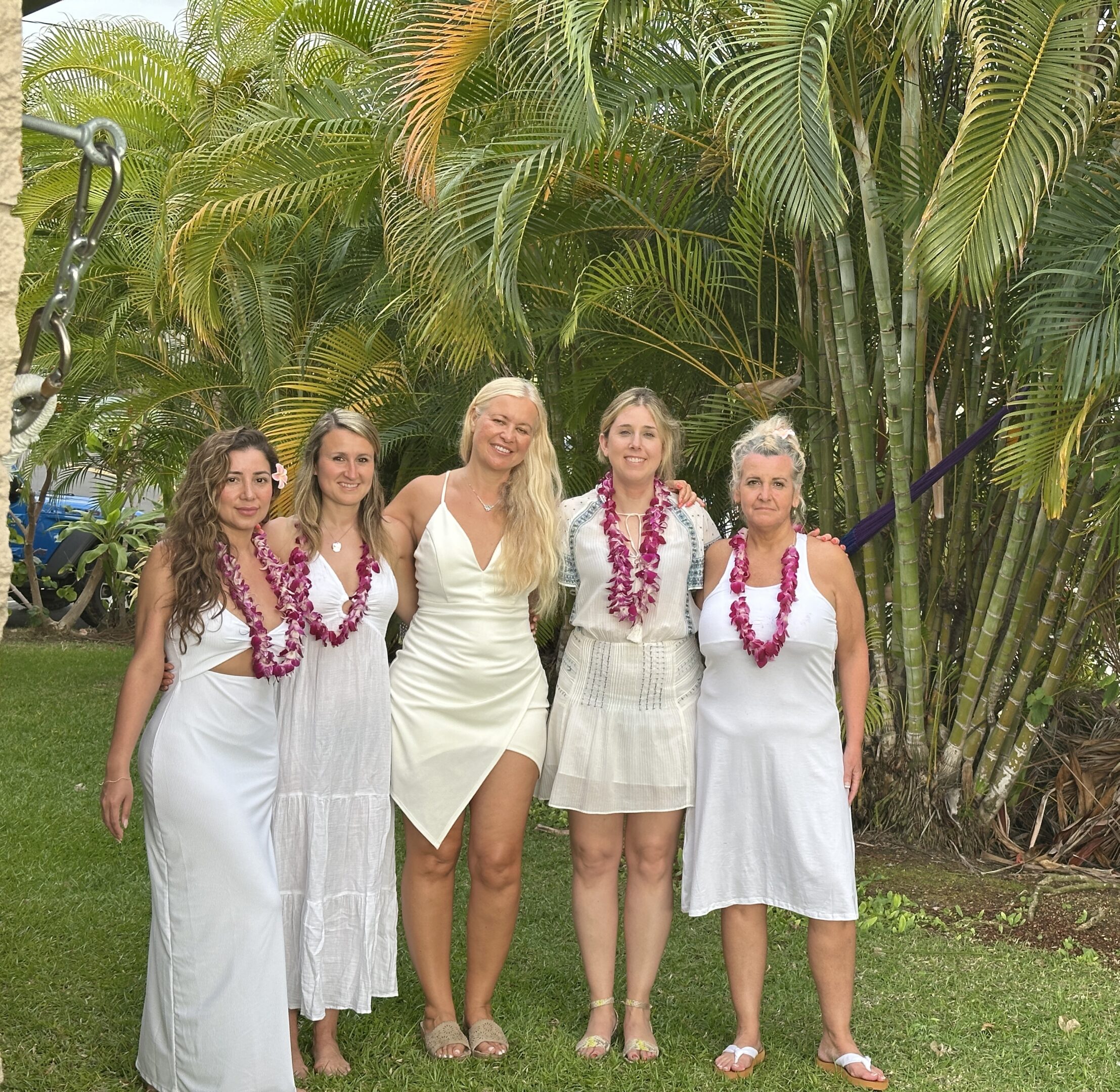 5 women dressed in white celebrating in hawaii